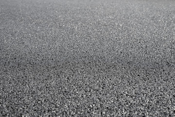 A new dark grey asphalt pavement texture.