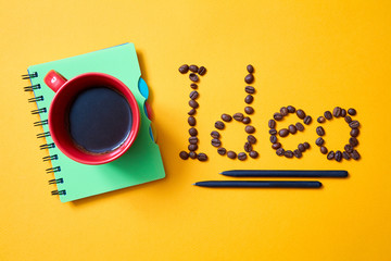Naklejka premium Creative, bright idea and innovation or inspiration concept. The inscription of coffee beans on a yellow background.