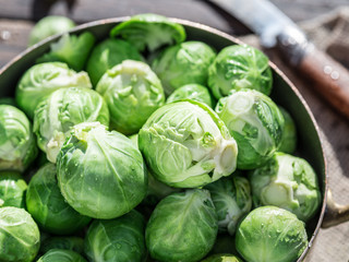 Fototapeta premium Brussel sprouts in the copper pan on the old wooden table.