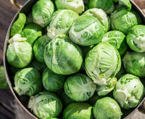 Fototapeta premium Brussel sprouts in the copper pan on the old wooden table.