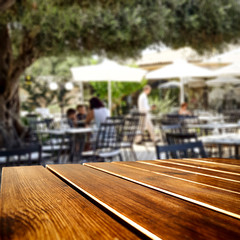 Table background  in a restaurant outdoor view. Empty  space for your decoration and an advertising product.