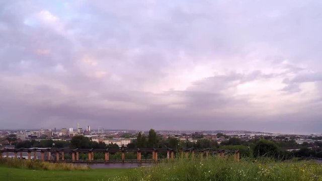 Cityscape timelapse fast moving cloud above Everton, Liverpool, British city harbour skyline from high viewpoint.