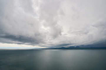 the endless water expanses of the lake Sevan on a cloudy day with clouds in the sky.