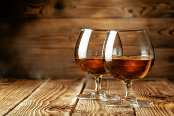 Two glasses of whiskey on a wooden table in the bar