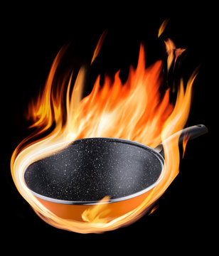 Burning Empty Wok Pan In Flames On The Black Background.