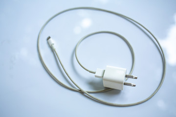 Smart Phone Charger Cable on white acrylic table background, Close up & Macro shot, Selective focus, Technology, Business concept