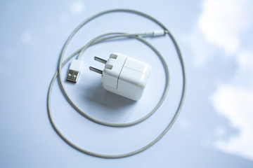 USB power adapter for devices, Charger Cable on white acrylic table background, Close up & Macro...
