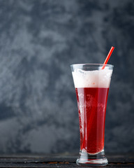 Raspberry sour beer ale on a dark background