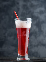 Raspberry sour beer ale on a dark background