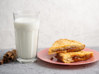 homemade cake with jam and a Cup of milk on the table