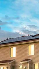 Vertical Multi storey home with solar panel on the roof against cloudy sky