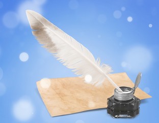 White feather quill pen, glass inkwell and old letter isolated on a white background