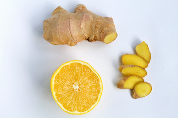 Fototapeta na wymiar fresh yellow lemon, slices of ginger, ginger root on white background top view