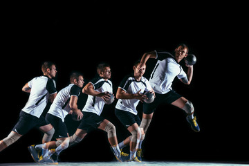 Fototapeta na wymiar Caucasian young handball player in action and motion in mixed and strobe light on black studio background. Fit professional sportsman. Concept of sport, movement, energy, dynamic, healthy lifestyle.