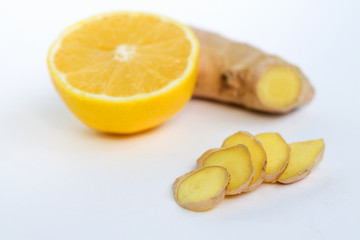 slices of ginger and fresh lemon on white background