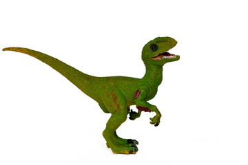 green dinosaur toy velociraptor with open mouth isolate