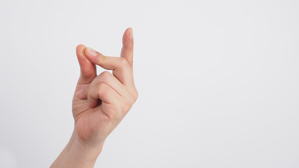 Male model is doing snap gesture hand sign on white background.