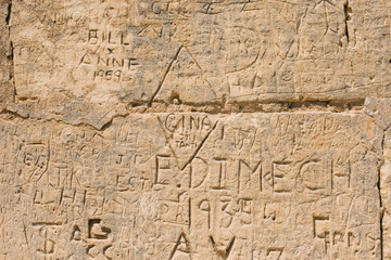 Fototapeta na wymiar scribbled inscriptions on the wall on a building in Mdina Malta. Vandalism