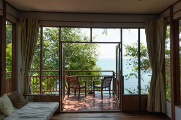 Inside the paradise house in the jungle with an ocean view wooden terrace blue sea and mountains.