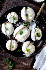 Whole baked potatoes with curd sauce and herbs