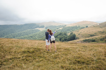 Fototapeta na wymiar Tourists girl and guy in the mountains of Montenegro