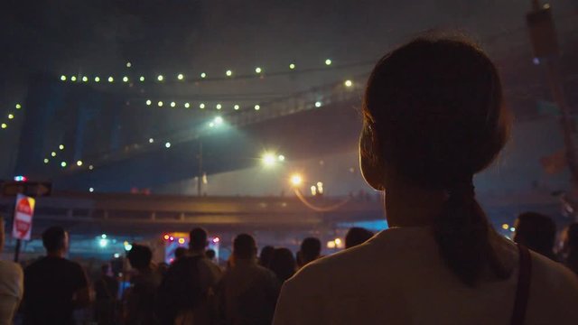 Young girl watching fireworks at Brooklyn Bridge in New York