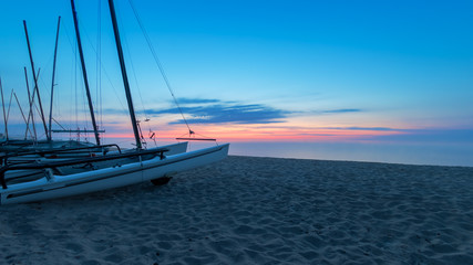 Sunrise with sailboats on the beach, Rosenfelder Strand on the Baltic Sea, Schleswig-Holstein. Northern Germany