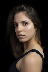 Portrait of a strong determined girl on a black background