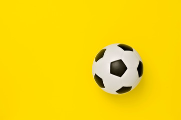 Soccer ball or football on yellow background