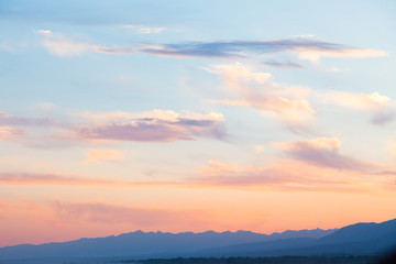 Pink vanilla heaven. Bright blue sky with gentle cumulus clouds. soft pastel colors