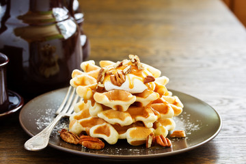 Homemade waffles with caramel and pecans.