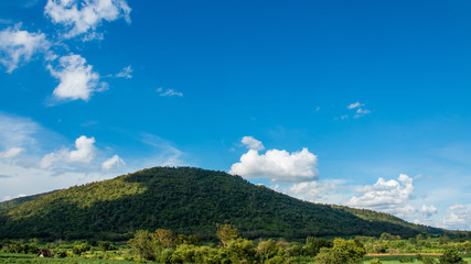 Fototapeta na wymiar Mountains and tree with beautiful blue sky and clouds.