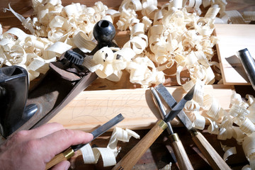 Carpentry tools for wood processing, shavings on a wooden table.