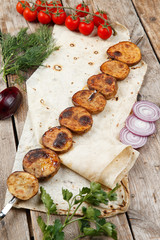 various barbecue skewers on a wooden table