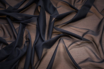 The texture of the synthetic fabric is black. Background, pattern.