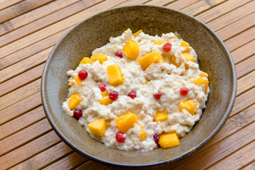 Oatmeal with mango and cranberries, healthy breakfast rich in vitamins and minerals