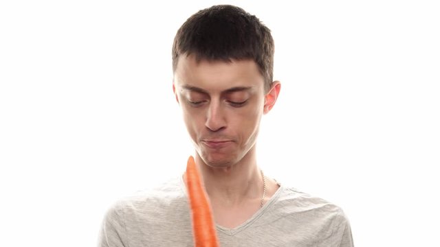 Man cant reach a carrot - white background - healthy food 