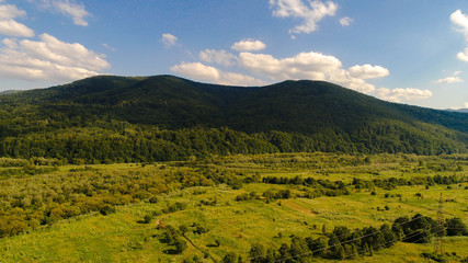 aerial view of big green hills with lot of trees in mountains