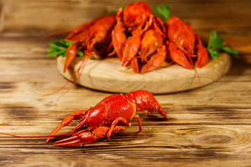 Boiled crayfish on cutting board on wooden table