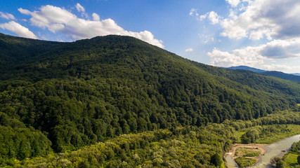 Obraz premium aerial view of big green hills with lot of trees in mountains