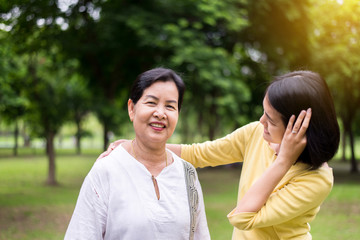 Middle asian mother happy with daughter talking together at outdoor in the morning,Happy and smiling,Take care and support concept