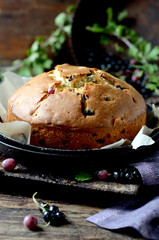 Cake with gooseberries on a dark wooden background