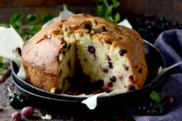 Cake with gooseberries on a dark wooden background