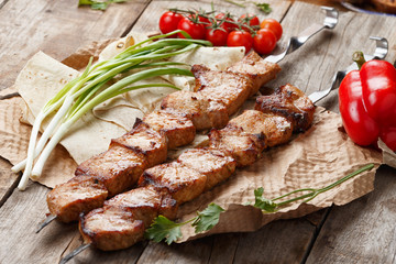 pork skewers on a wooden table, selective focus