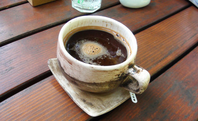cup of coffee on wooden table