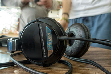 Obraz na płótnie Canvas black headphones lie on the director desk by sound.
