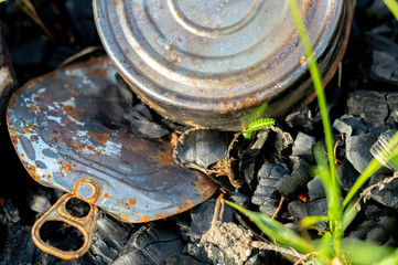 tin can in the fire, garbage after tourists