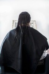 brunette woman drying her hair at a hairdresser