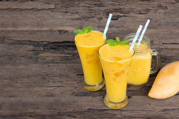 Mango smoothies juice orange fruit juice milkshake blend beverage healthy high protein the taste yummy in glass episode drink morning on wood background.