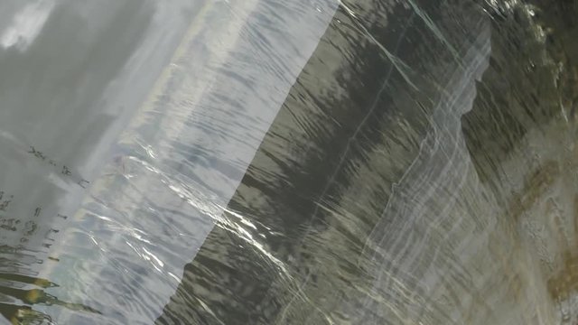 slow motion, water stream flowing in floodgate of small dam